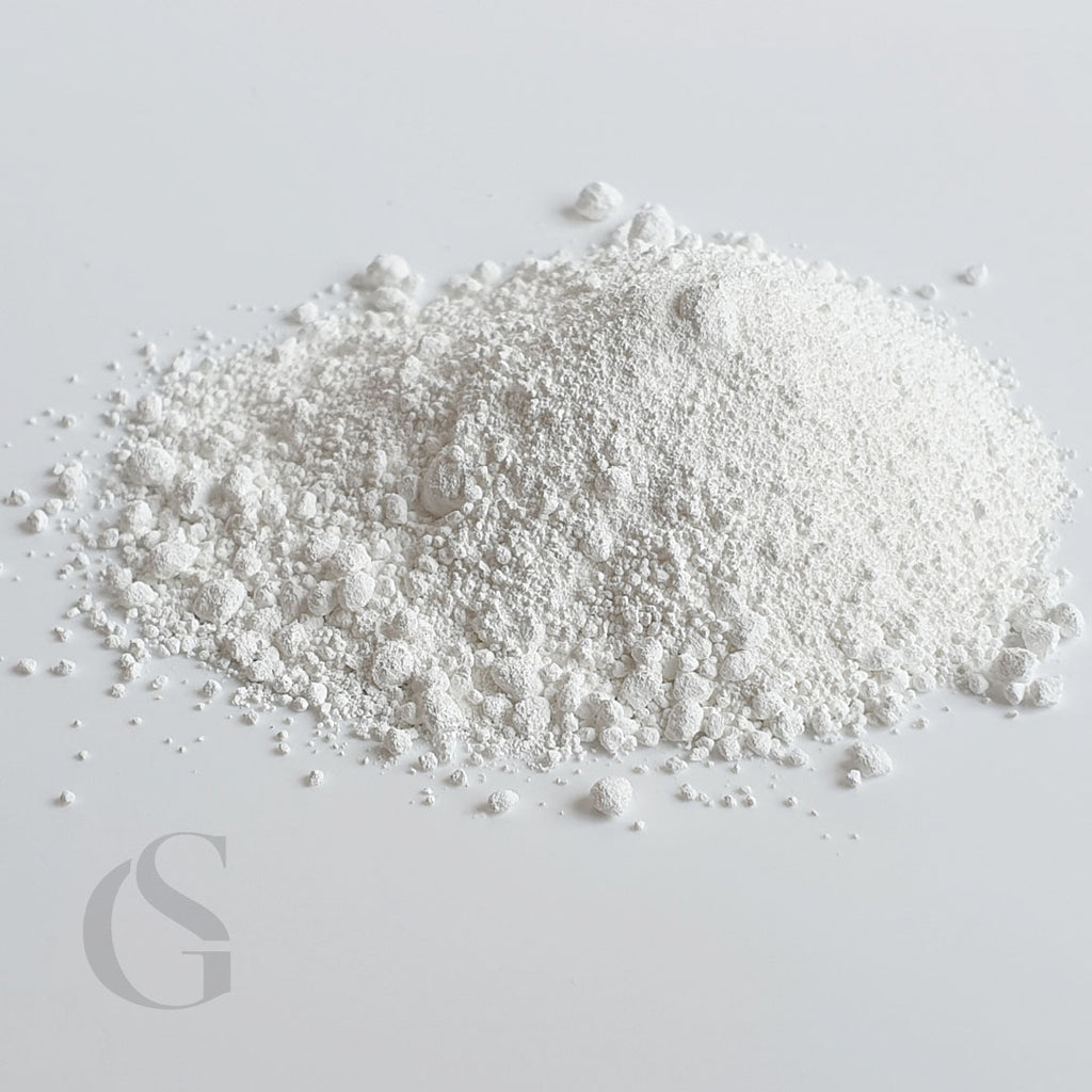 white, slightly crumbly looking powder on a soft grey background