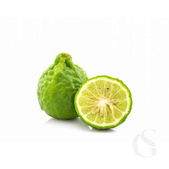 Green fruit, a bergamot, with a halved version on a white background.