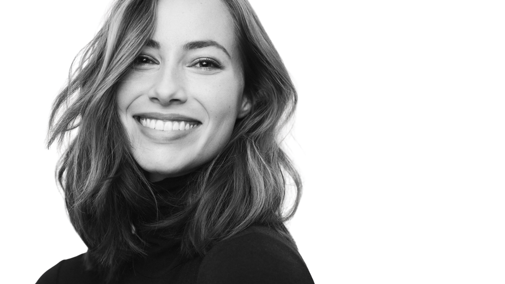Black and white portrait of a woman with a neutral background