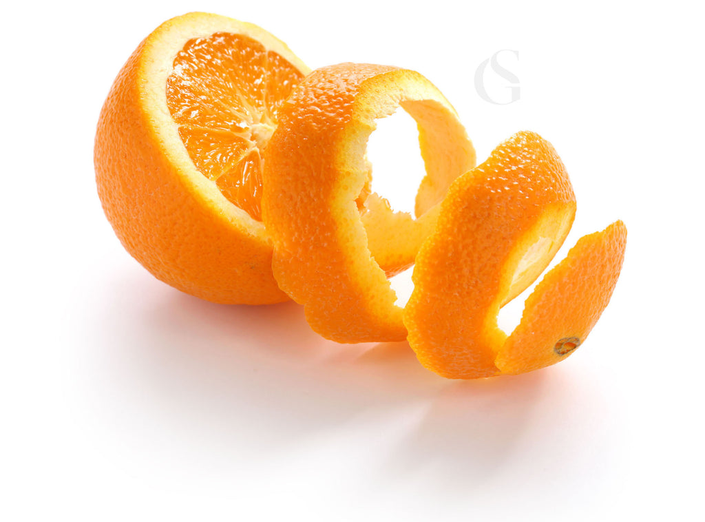 an orange sliced in a circular pattern where the peel falls to the right, white background