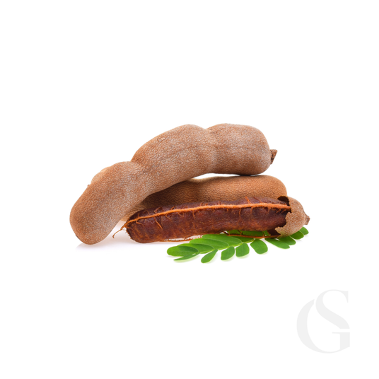 Two tamarind pods with green leaves on a white background