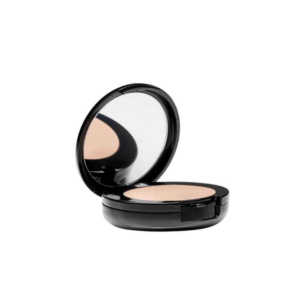 Round black compact with lid open to show mirror and makeup, makeup reflection in the mirror