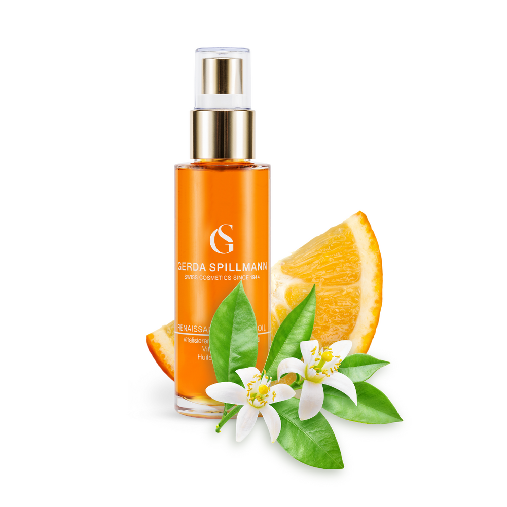 Orange bottle with gold cap on a white background, featuring oranges and flowers.