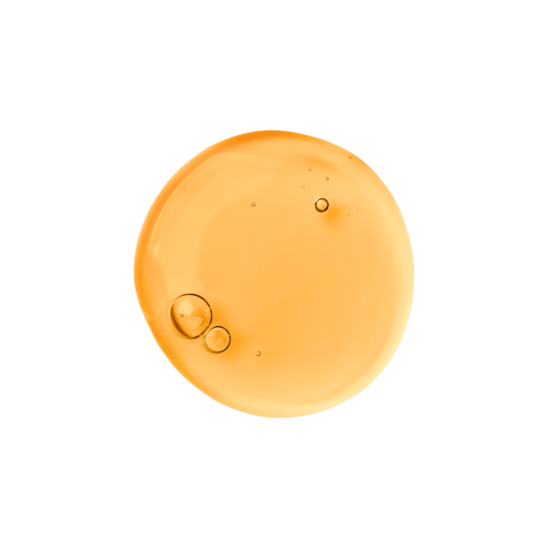 Orange-colored liquid droplet with bubbles on a white background
