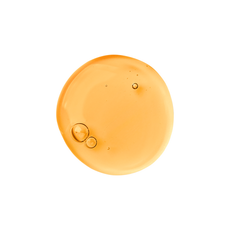 Orange-colored liquid droplet with bubbles on a white background