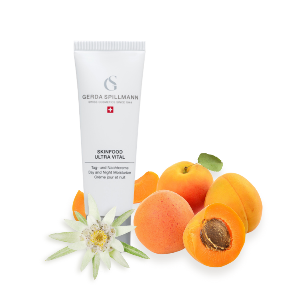 Tube of Gerda Spillmann skincare product with apricots and a flower on a white background