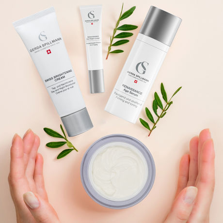 anti-aging products spilled out in front of hands with greenery surrounding