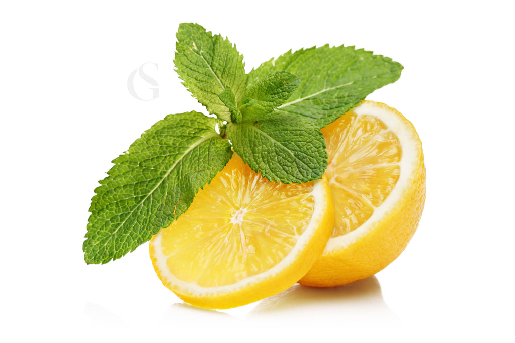 sliced open lemon with mint leaf on a white background